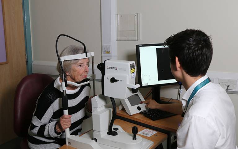 Dr Siegfried Wagner giving a Parkinson's patient an OCT eye scan.
