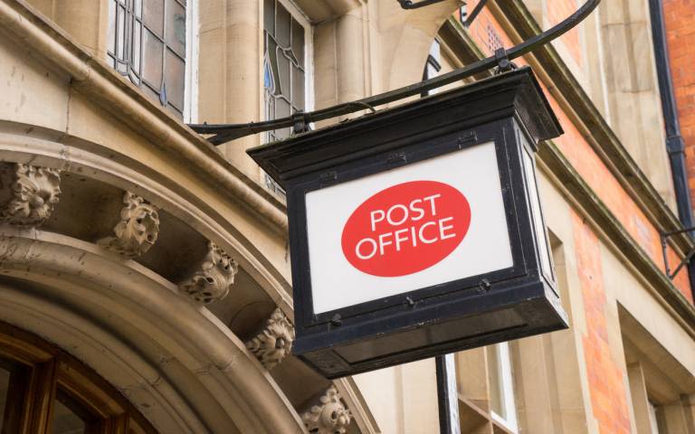 Post Office signage on building exterior.