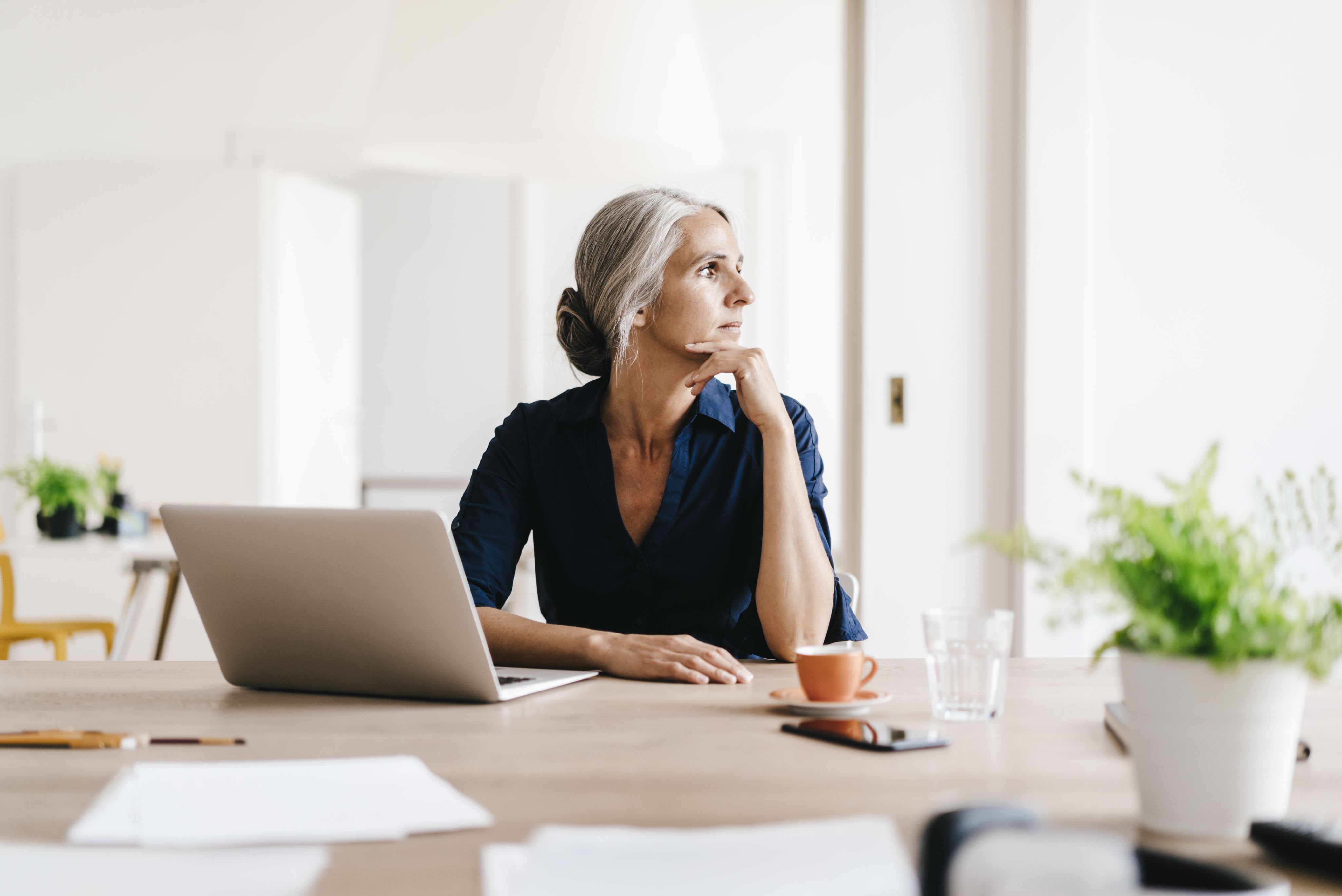 Businesswoman working on laptop in office.