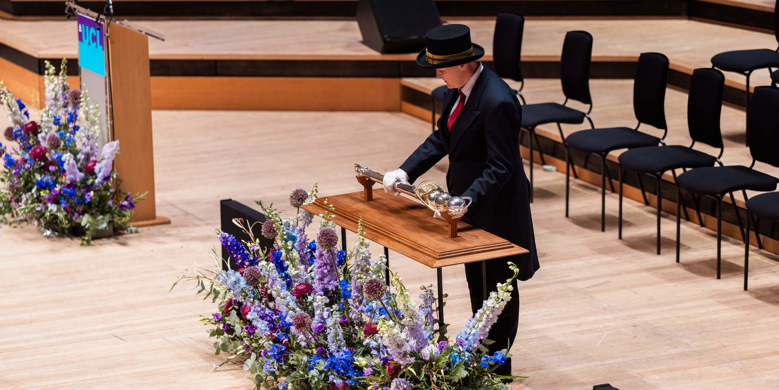 The Mace being laid on a table on the stage