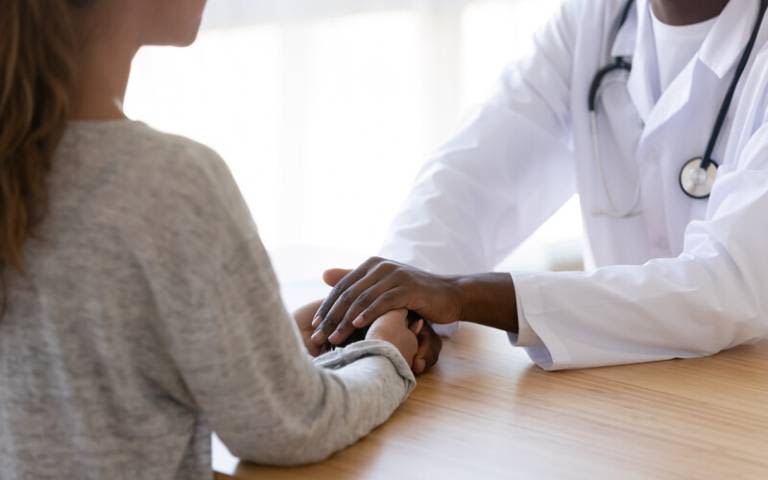 A patient and healthcare professional. Credit: fizkes (iStock)