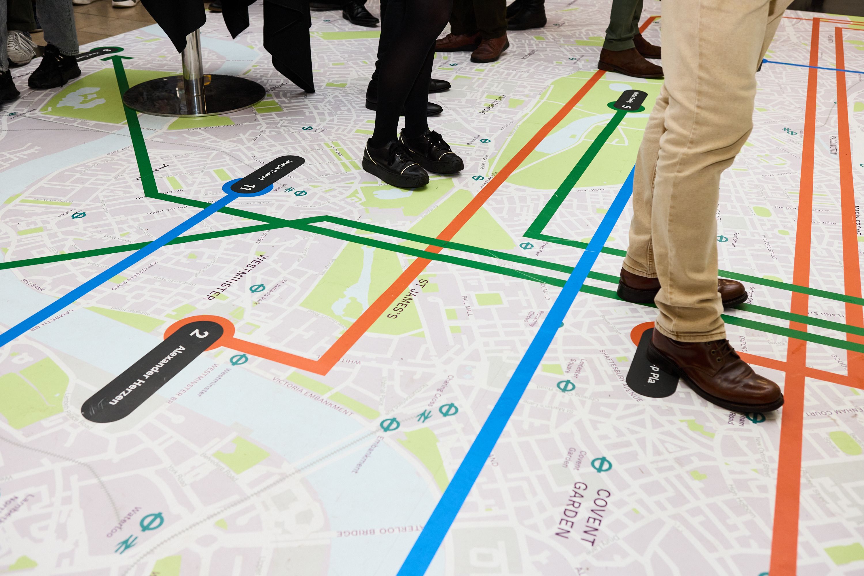 People stood on floor map illustrating literary map
